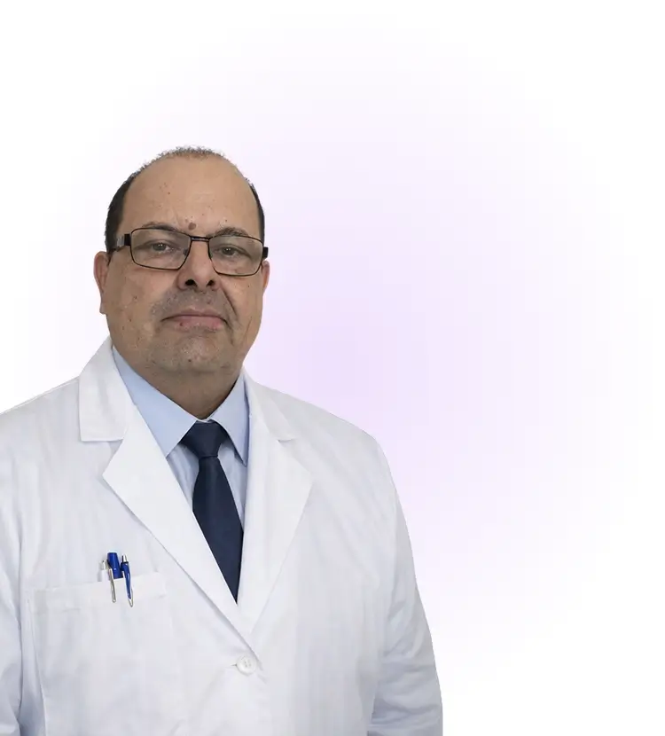 A man wearing a white lab coat and a tie, standing confidently in a professional setting.